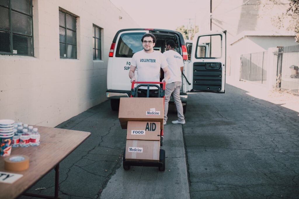 Two Men Carrying Boxes